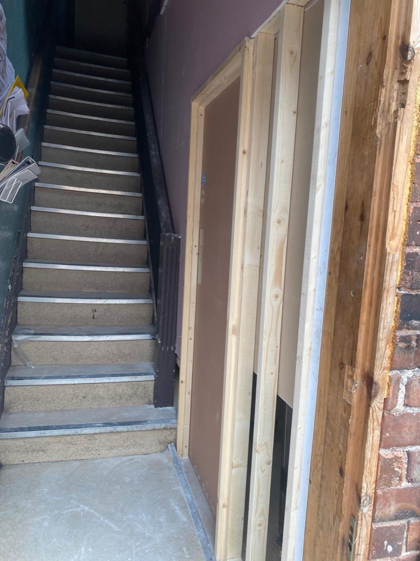 Stairwell with newly installed door frames awaiting doorsets