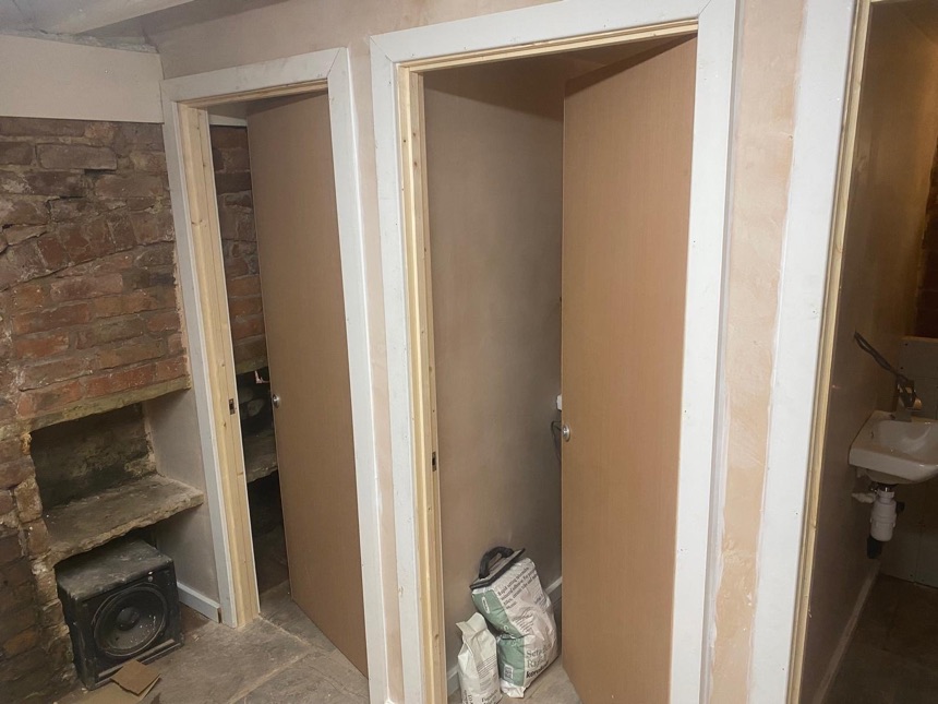 Washroom refurbishment in progress with new partitions and doors